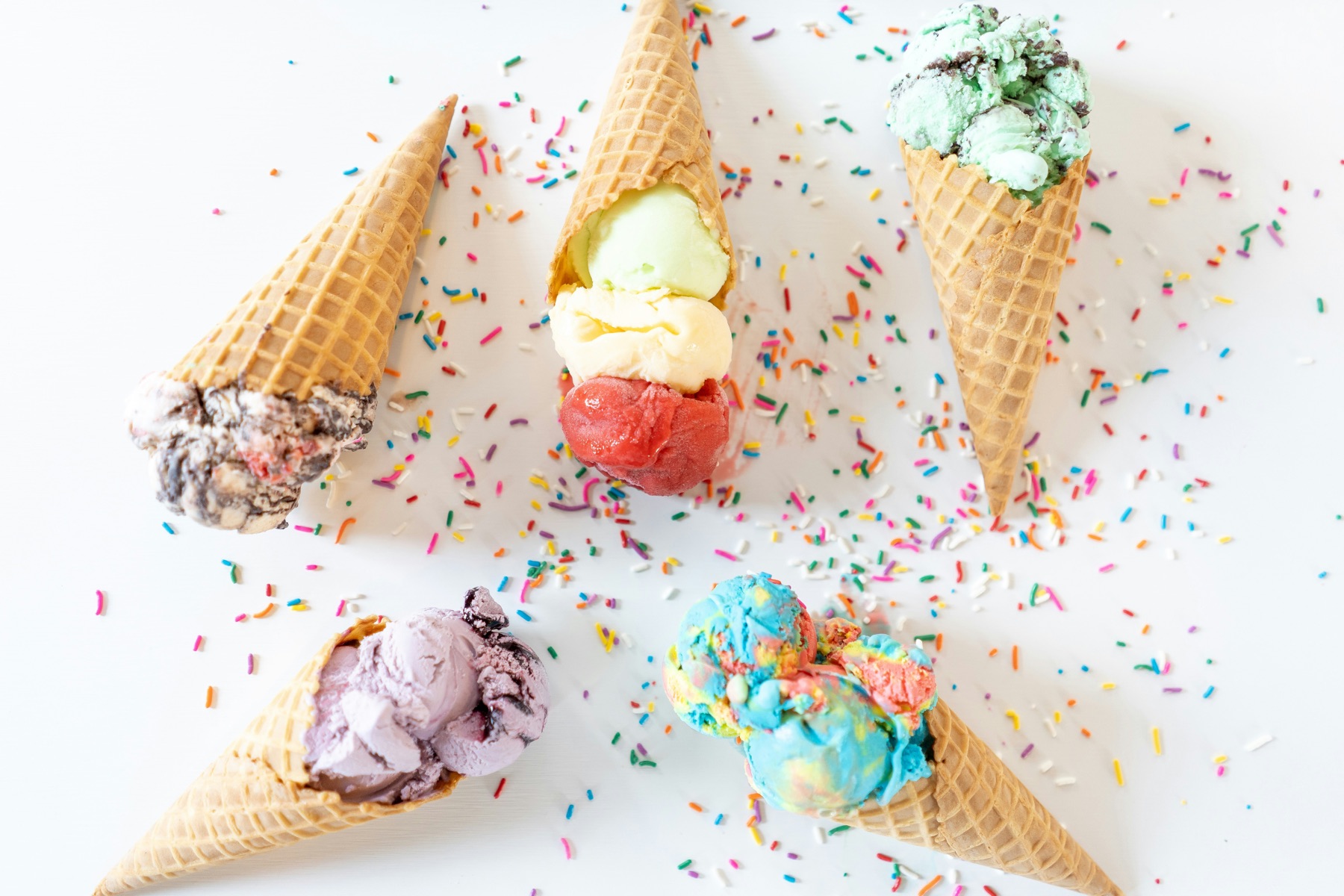 Colourful gelato cones on a bright table