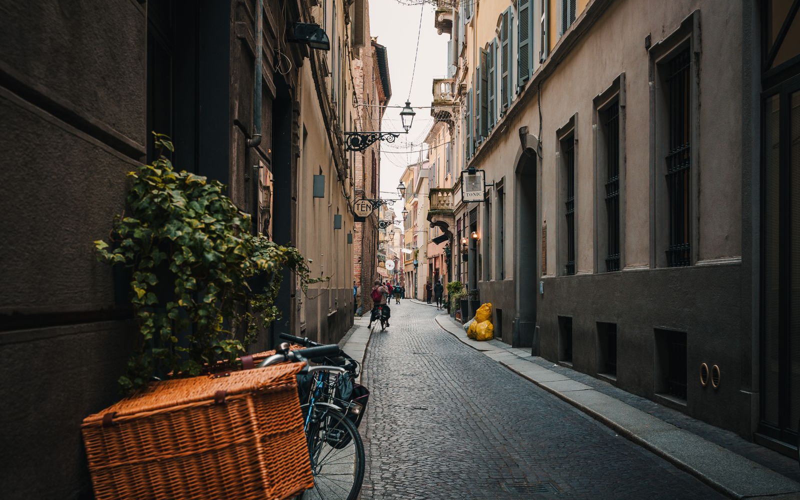 Bicycles parked along a narrow cobbled street in Verona