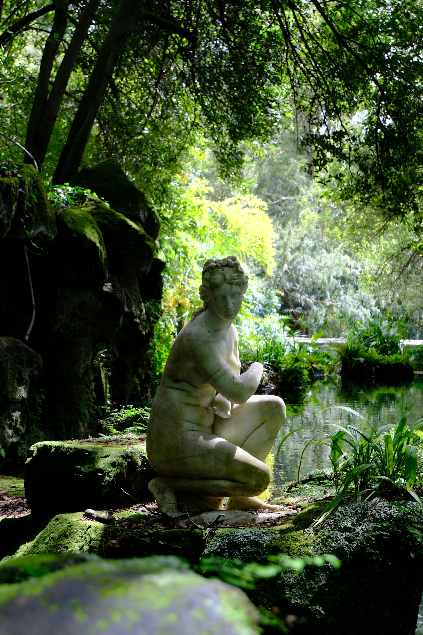 A white marble statue in an Italian garden