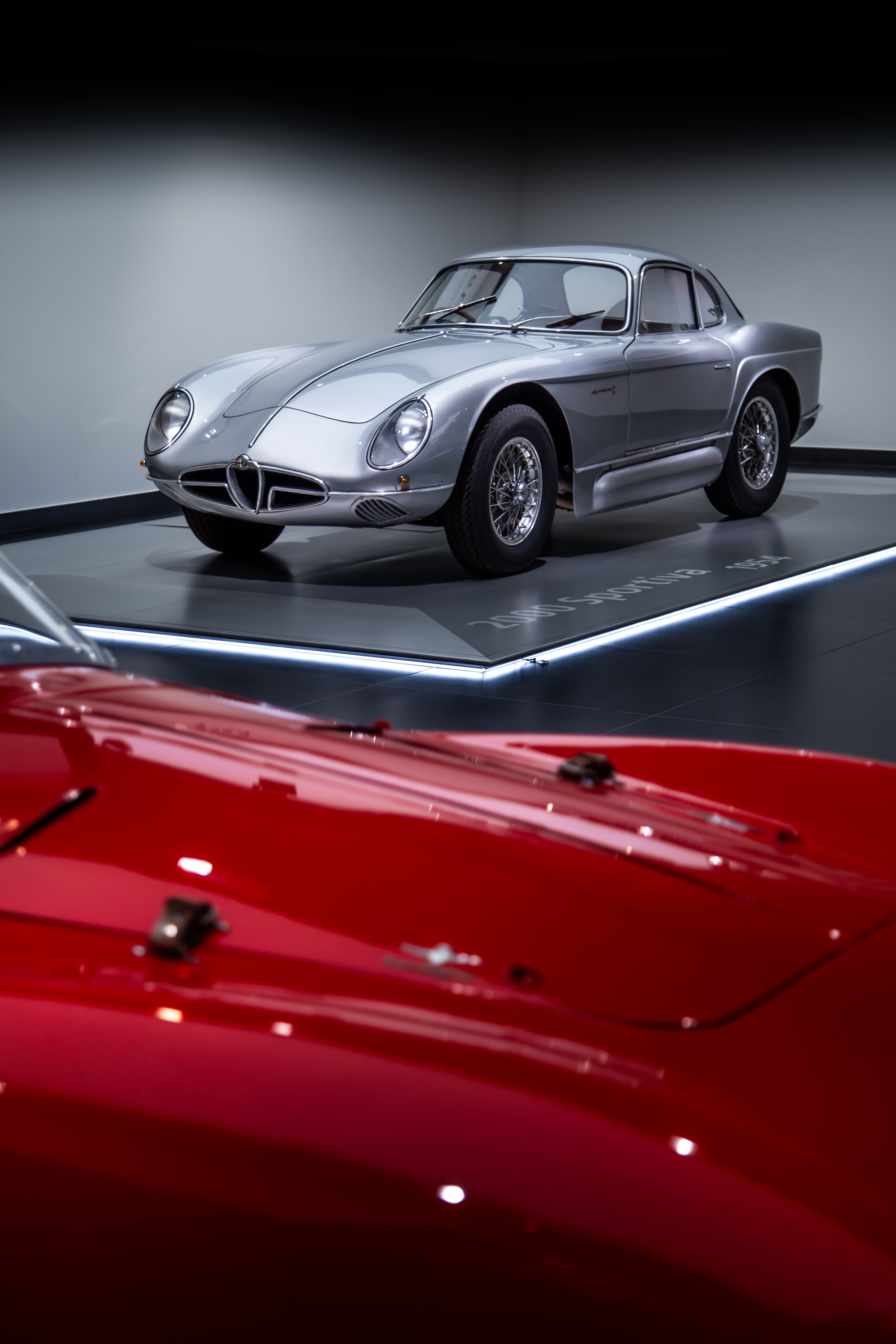 Classic cars displayed inside a museum exhibition
