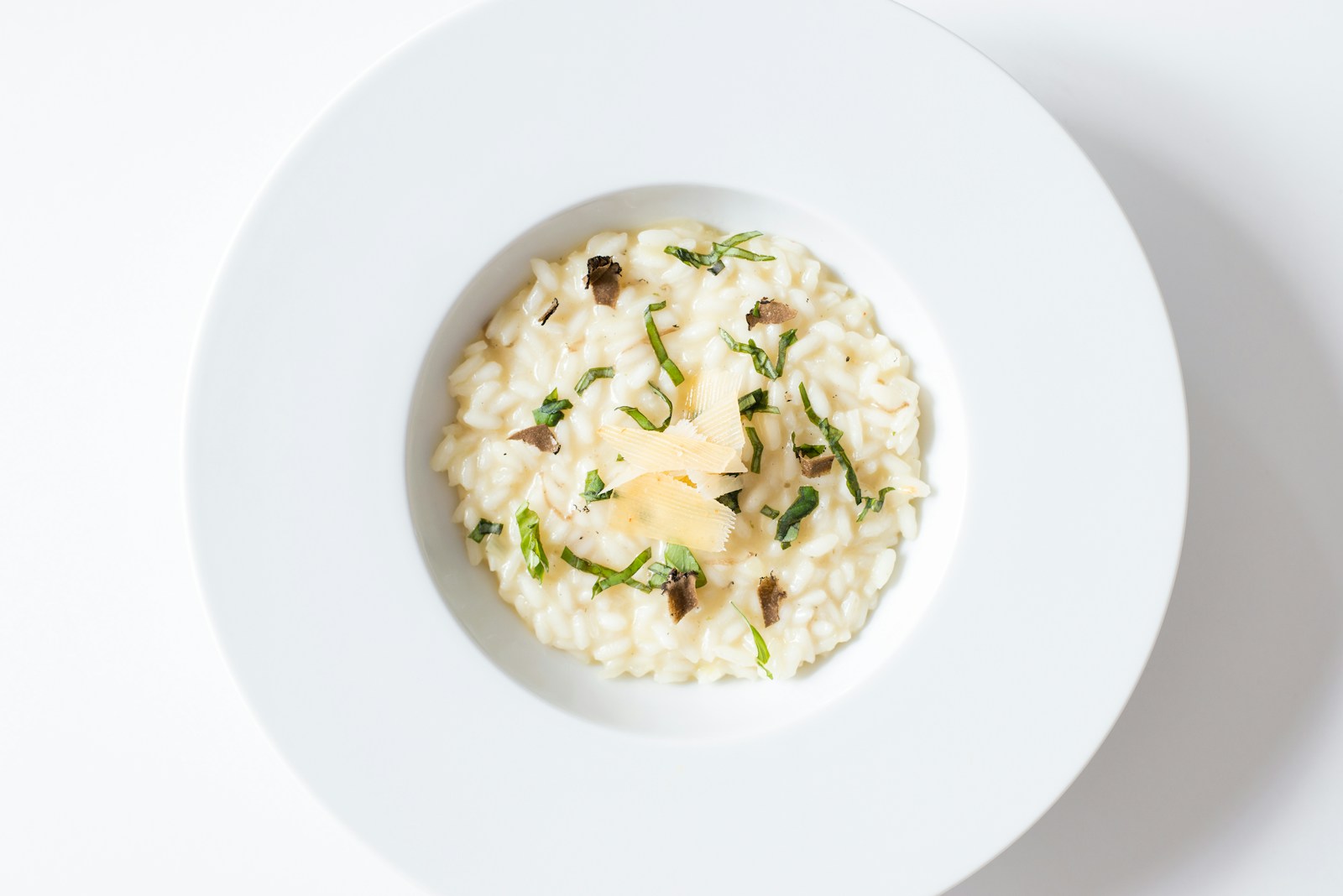 A bowl of creamy risotto topped with herbs