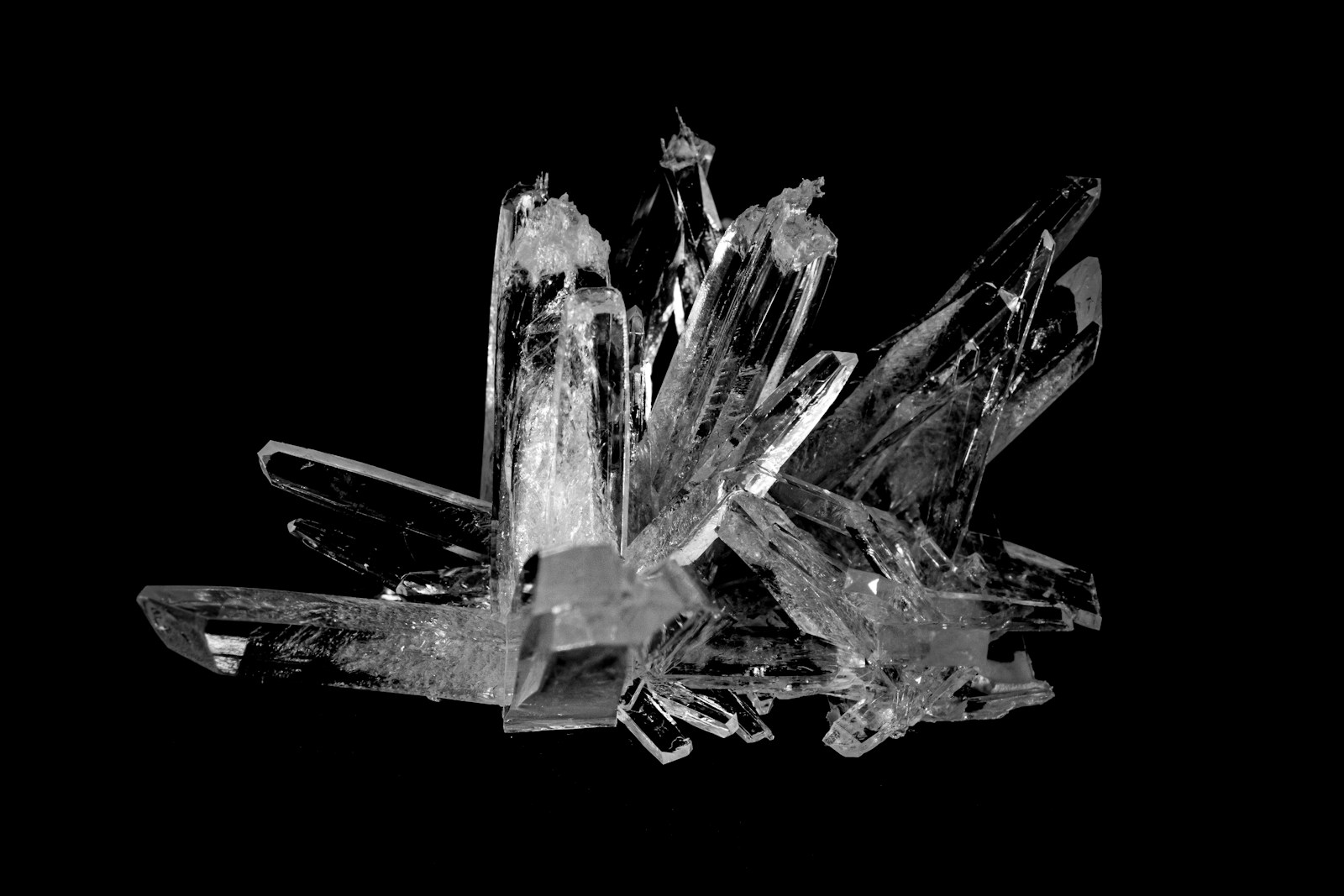 Clear quartz crystals photographed against a dark background