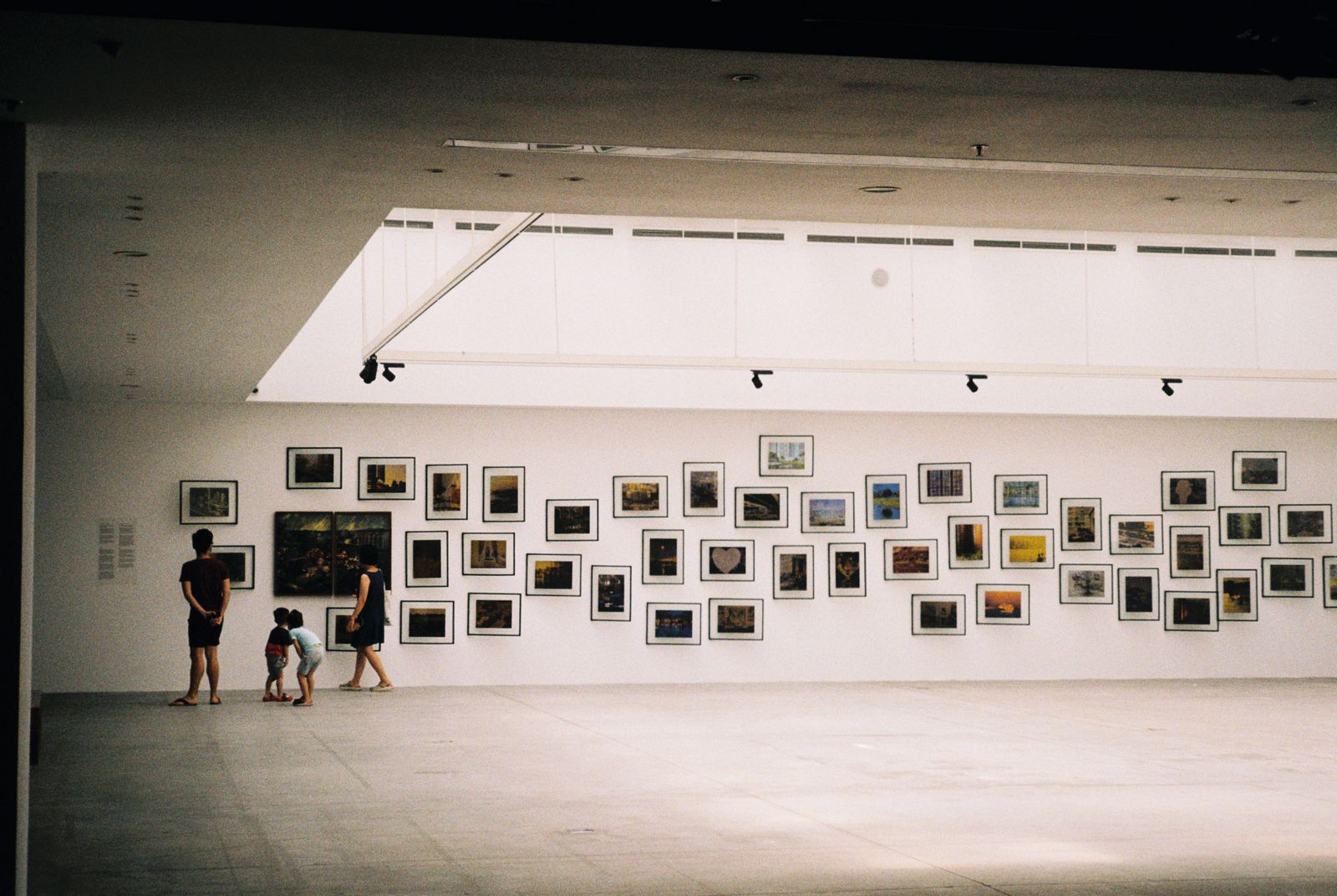 A family looking at art in a modern museum gallery