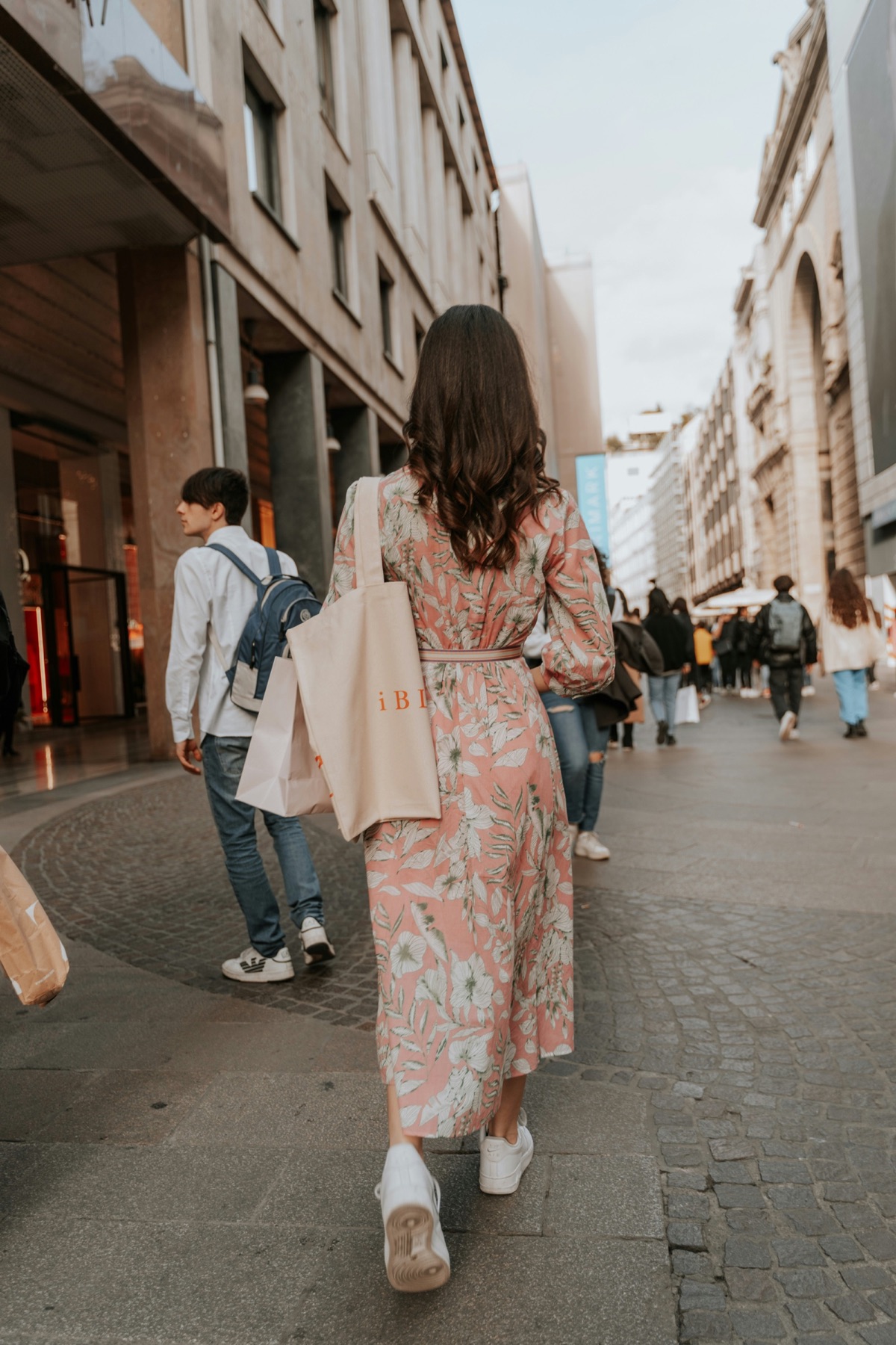 A shopper walking through an Italian city street